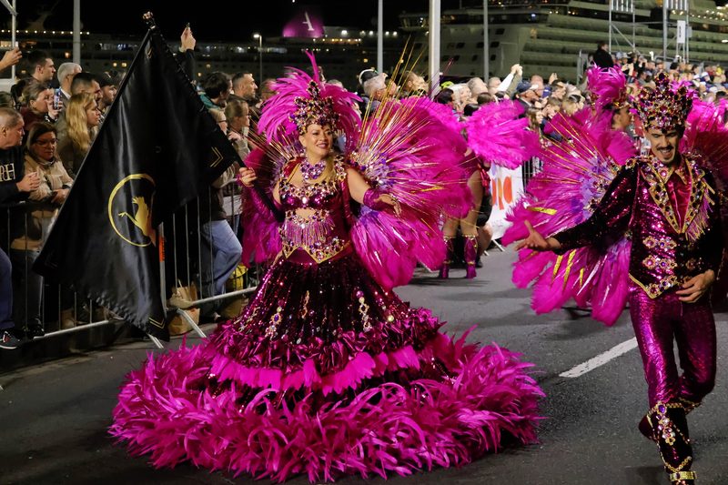 Carnival da Madeira samba parade pink feathers colorful costumes Funchal night