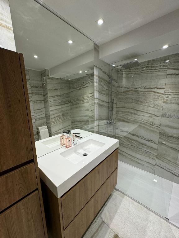Infante Home — luxury marble bathroom with walk-in shower