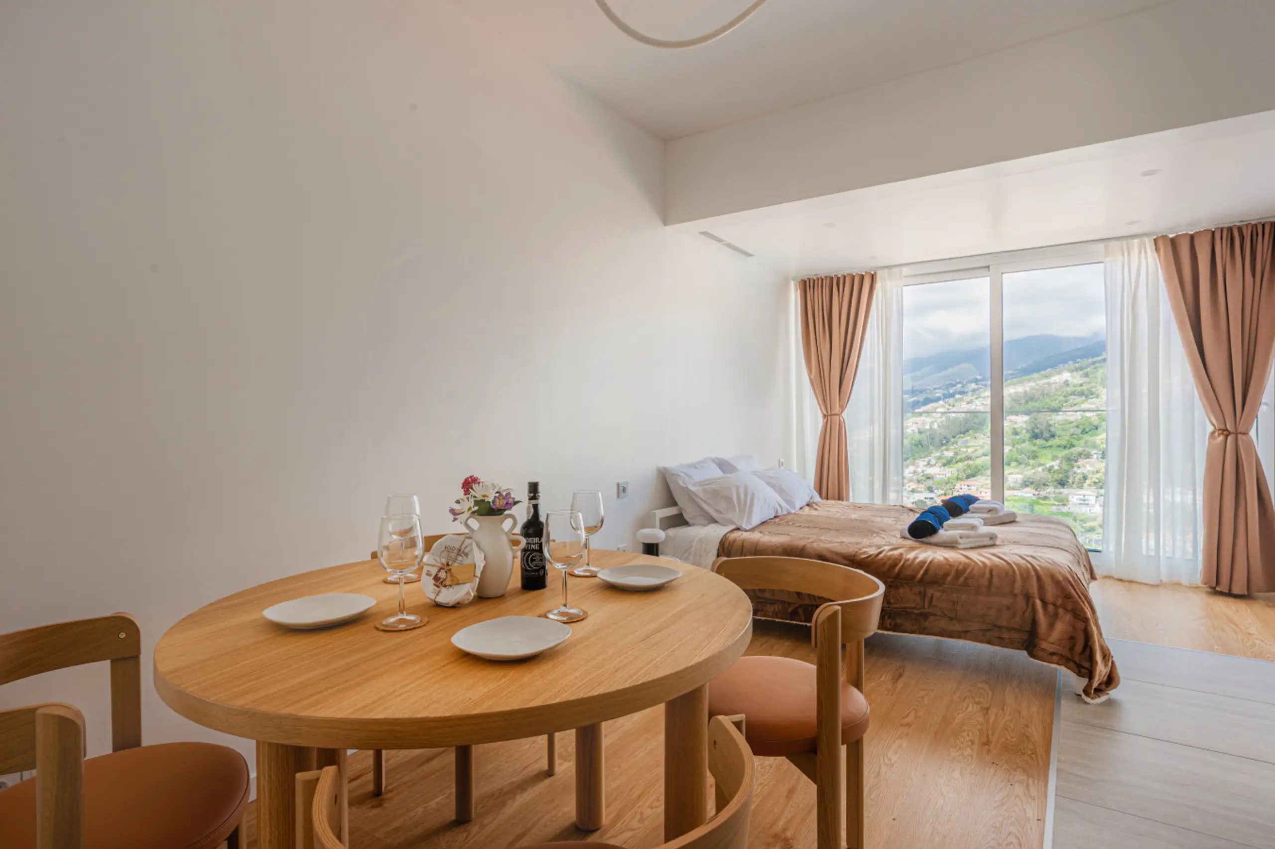 Studio living area with king bed, kitchen and mountain view window